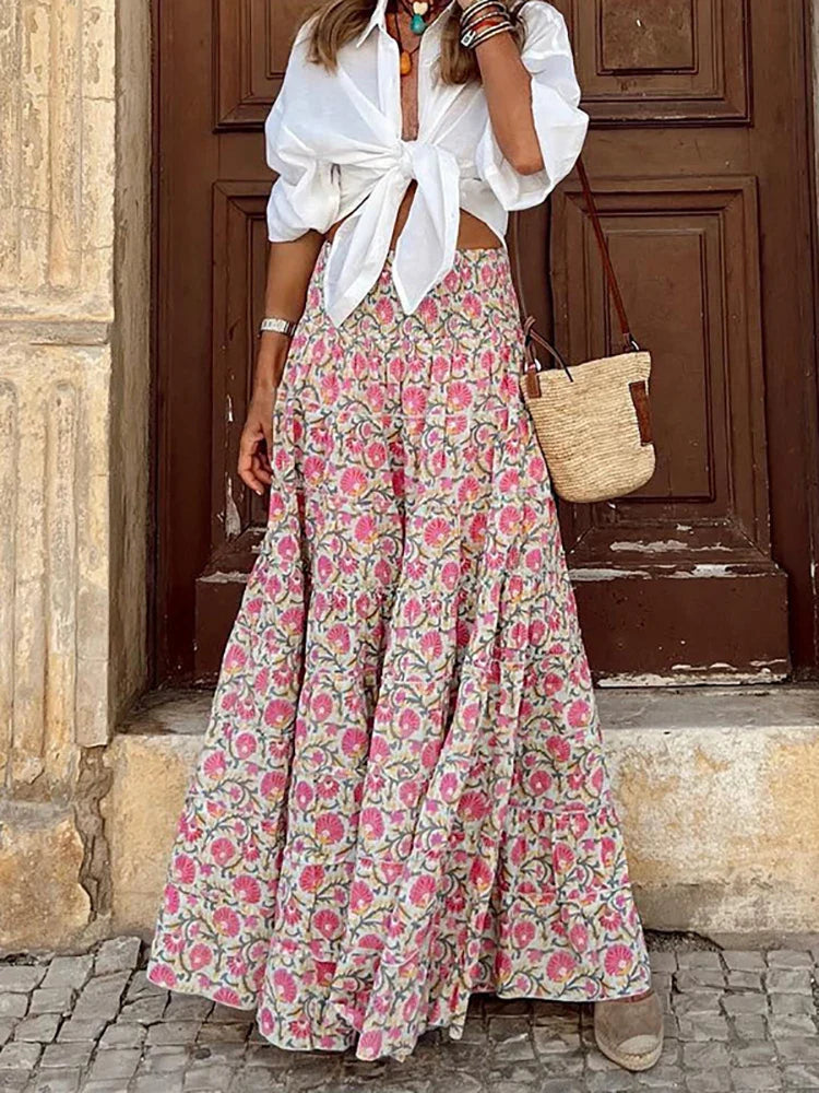 Shioban is een elegante boho maxi-rok met een flowy design, hoge taille en elastische tailleband met trekkoord voor de perfecte pasvorm. Gemaakt van een zachte polyester-spandexmix voor ultiem comfort. Met handige zijzakken voor extra functionaliteit. Ideaal voor casual dagen, kantoor of avondjes uit. Verkrijgbaar in Pink en Pink-Red, maten XS-XL. Voeg tijdloze stijl toe aan je garderobe met Shioban. Bestel nu en straal elegantie en comfort uit!